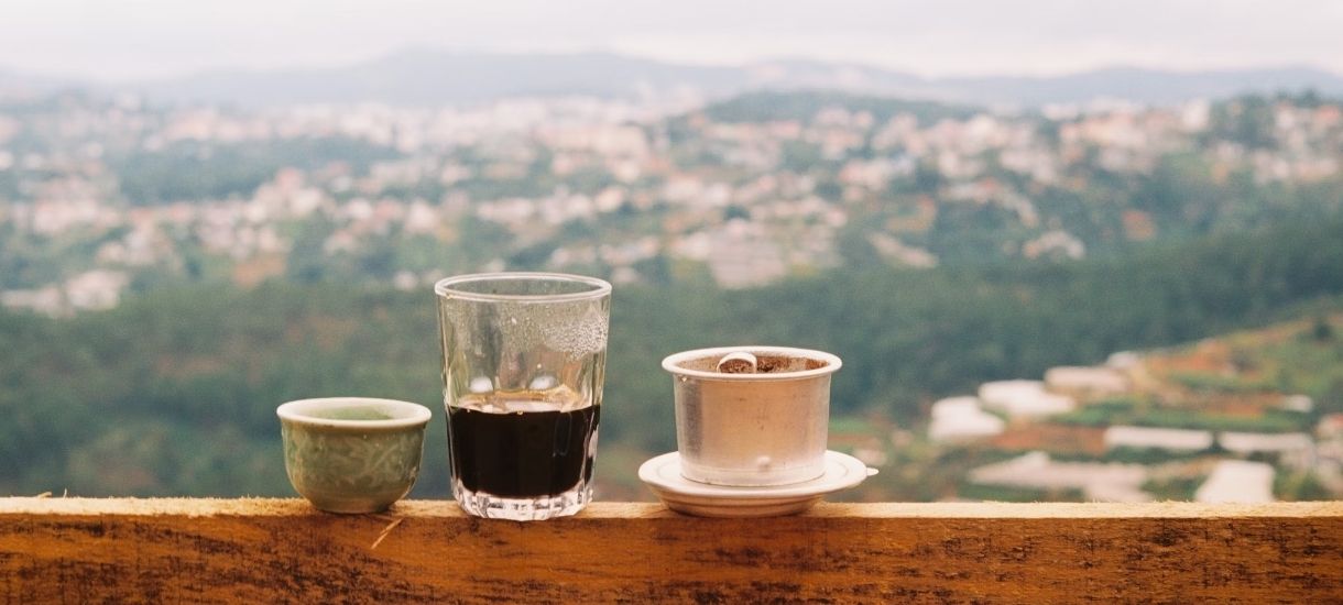 sit on a low chair, take small sips of Ca Phe Sua Da (Vietnamese Iced Coffee) while watching the local life passing by